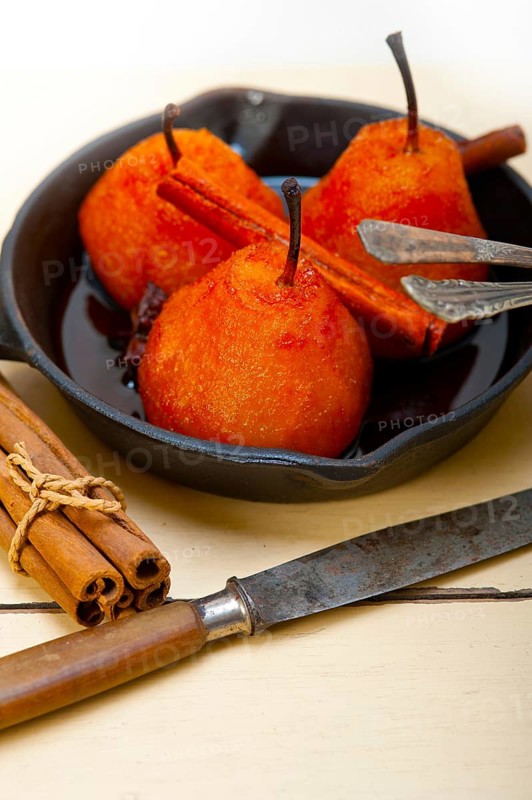 Poached pears delicious home made recipe ove white rustic wood table