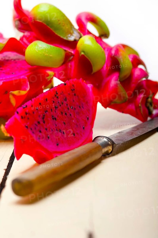 Fresh thai purple dragon fruit over white rustic table