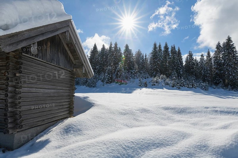 Winter landscape with wooden cabin
