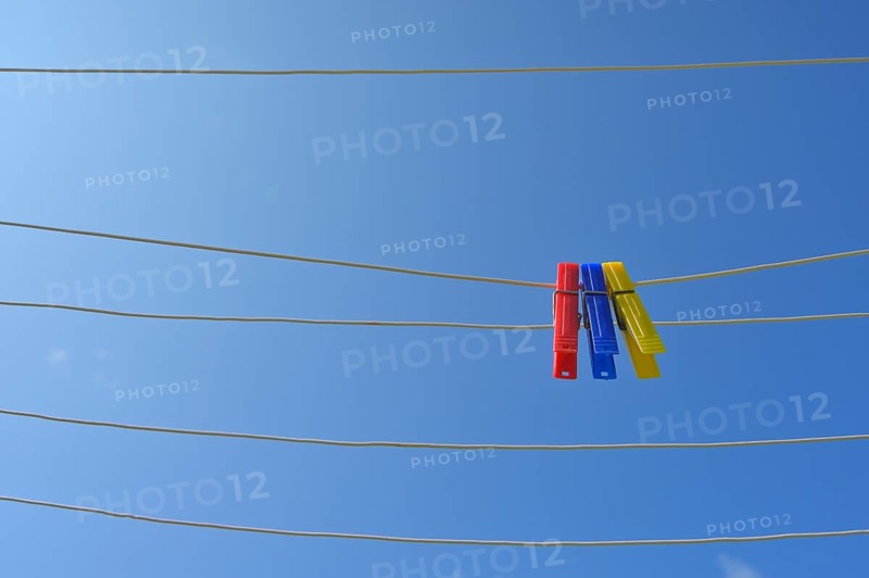 Clothesline with clothespins against blue sky