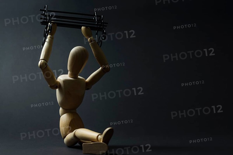 The mannequin holds a bench in its hands