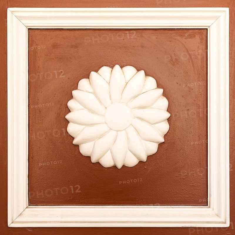 Wooden rosette as decoration on a front door