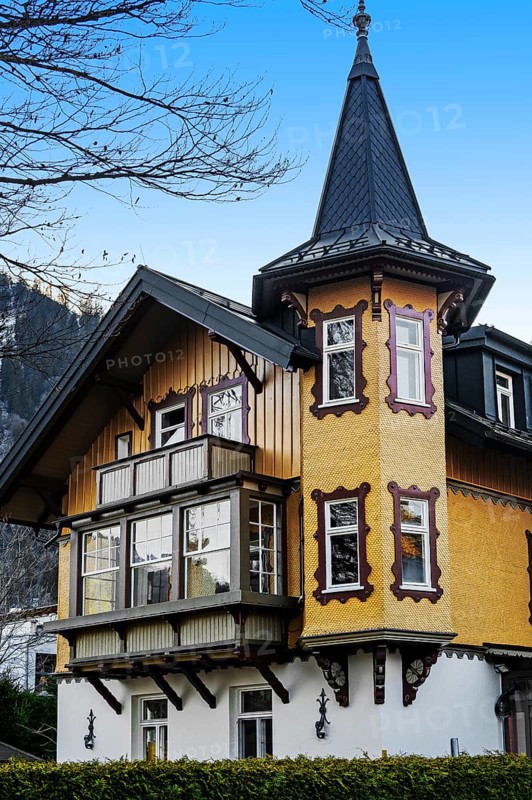 House with wooden shingles and oriel turret