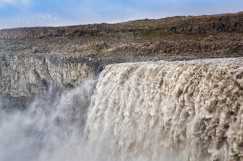 Hikers at the edge of Dettifoss