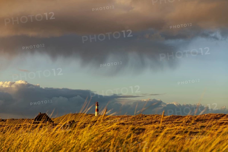 Dune landscape with storm clouds and List-ost lighthouse