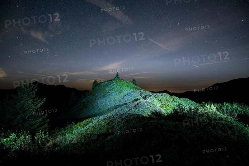 Peak lit by torch from Portlakopf