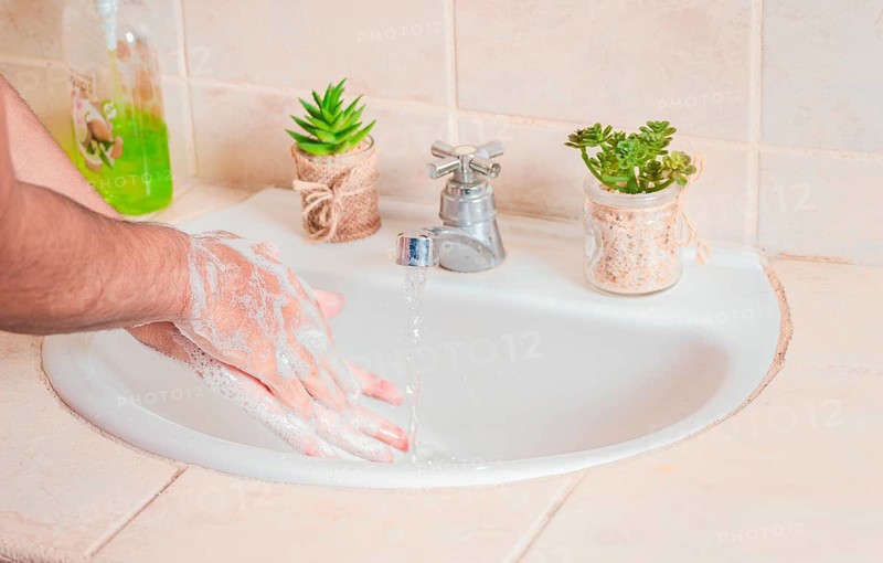 Close up of a person washing their hands with soap