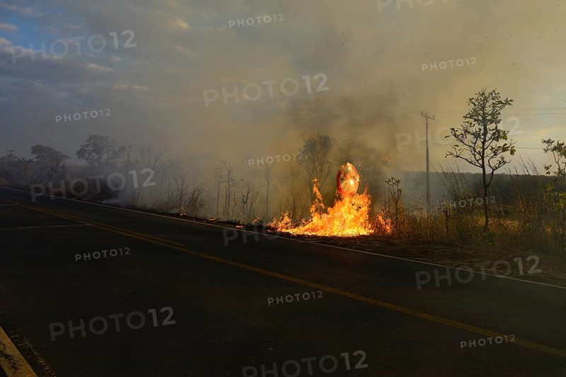 Burning road sign in a bushfire on the main road 251