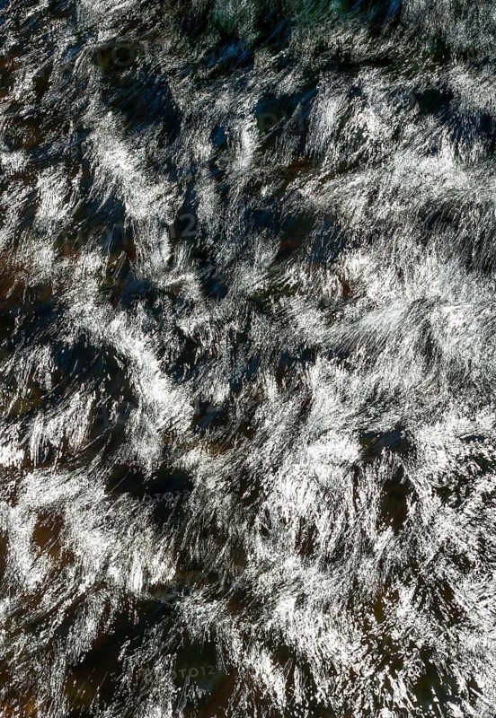 Flowing water with light reflections