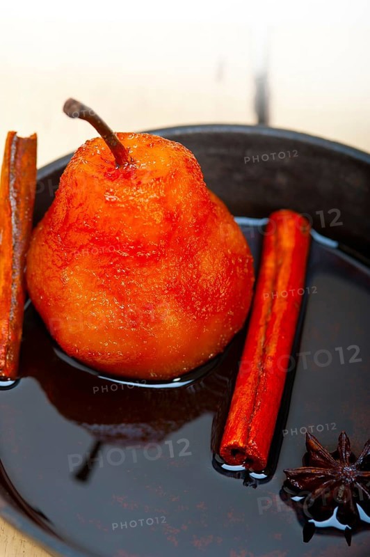 Poached pears delicious home made recipe ove white rustic wood table