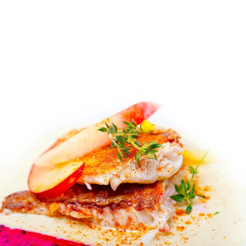 Sea bream orata fillet butter pan fried with fresh peach prune and dragonfruit slices thyme on top
