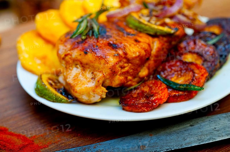 Roasted grilled BBQ chicken breast with herbs and spices rustic style