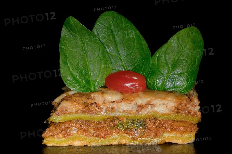 Classic lasagne with spinach leaves and tomato