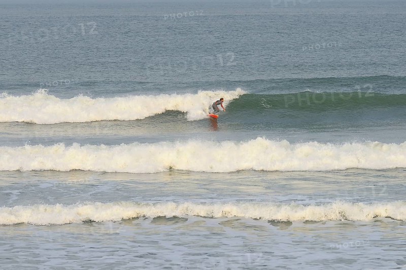 Surfer riding the wave at Praia de Mocambique