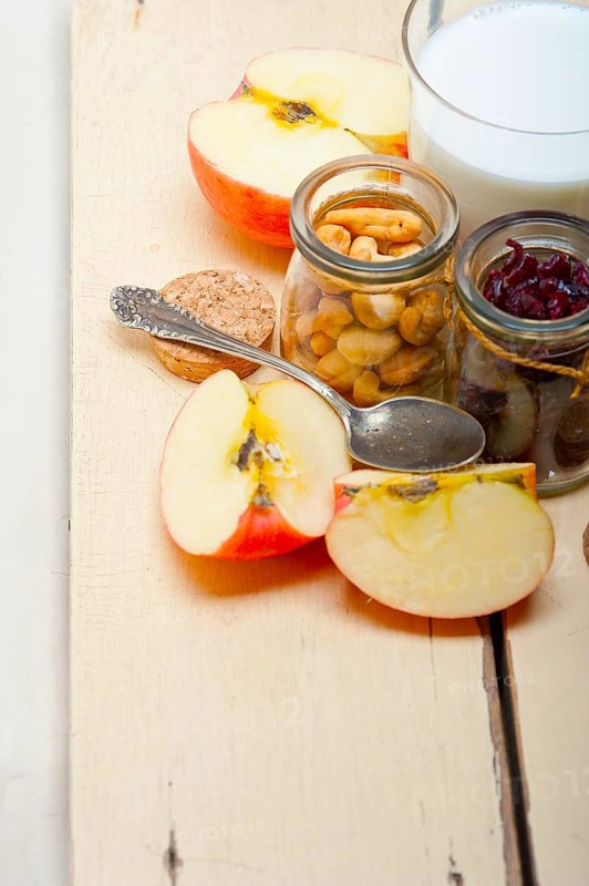 Healthy breakfast ingredients milk oat cashew nuts dried cramberry craisinns