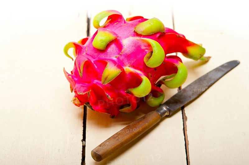 Fresh thai purple dragon fruit over white rustic table
