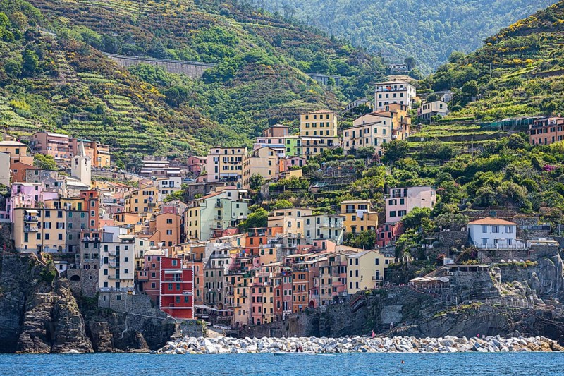 The village of Riomaggiore with its nested pastel-coloured houses built into the hillside