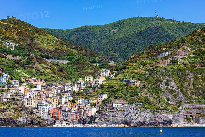 The village of Riomaggiore with its nested pastel-coloured houses built into the hillside