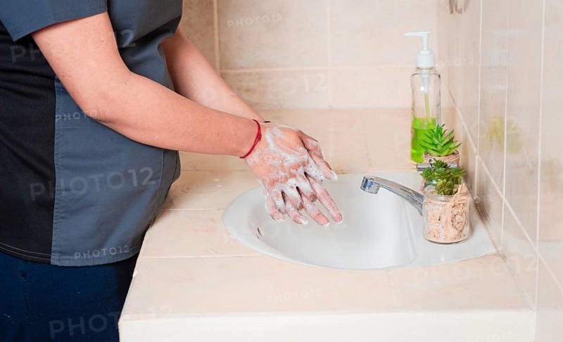 Close up of a person washing their hands with soap