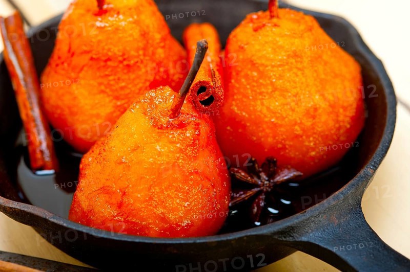 Poached pears delicious home made recipe ove white rustic wood table