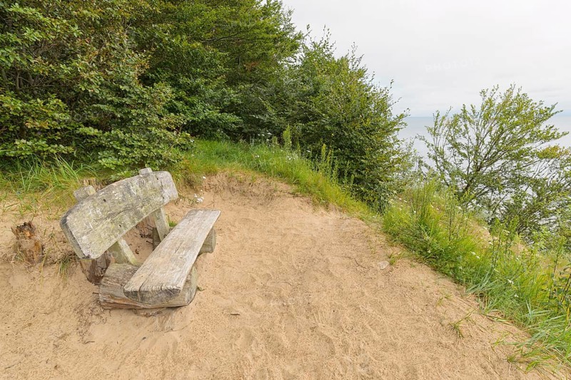 Bench on steep coast at sunrise