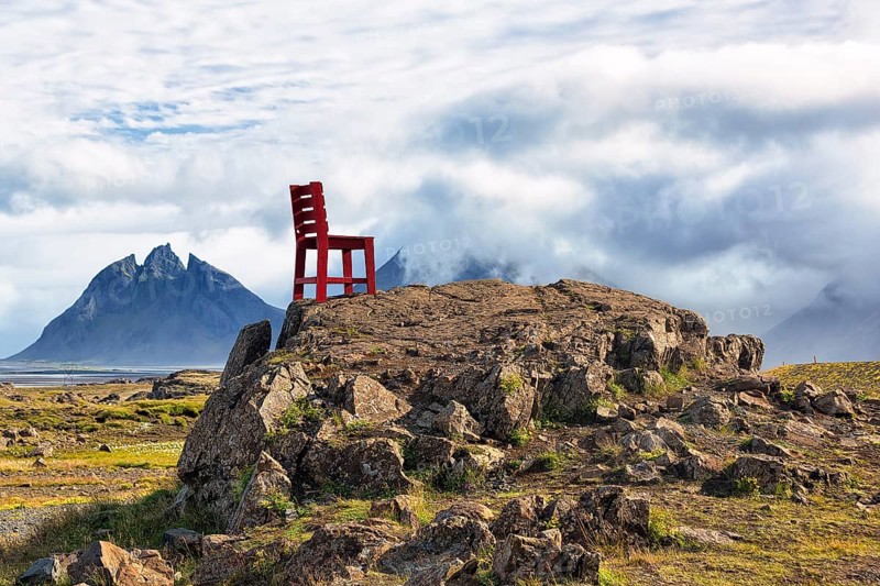 Red wooden chair on a rock