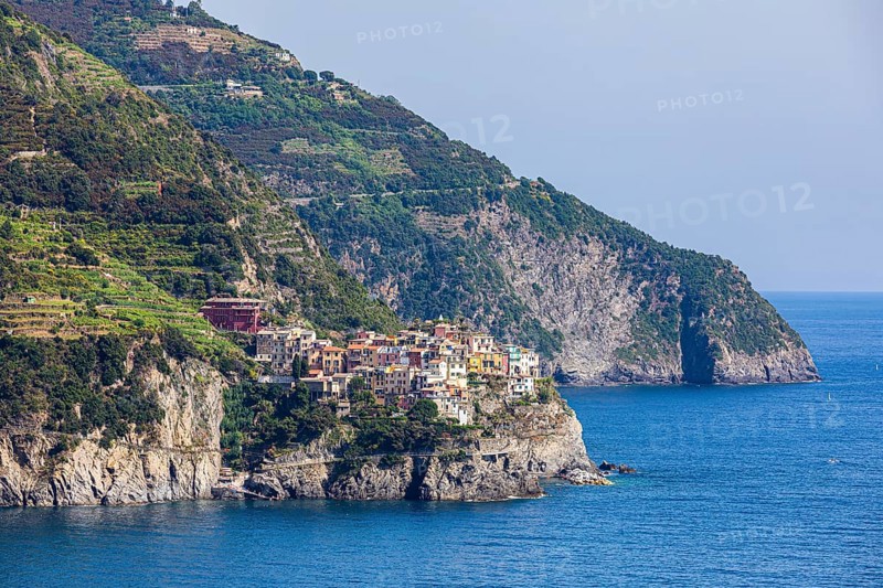 The village of Corniglia with its nested pastel-coloured houses built into the hillside