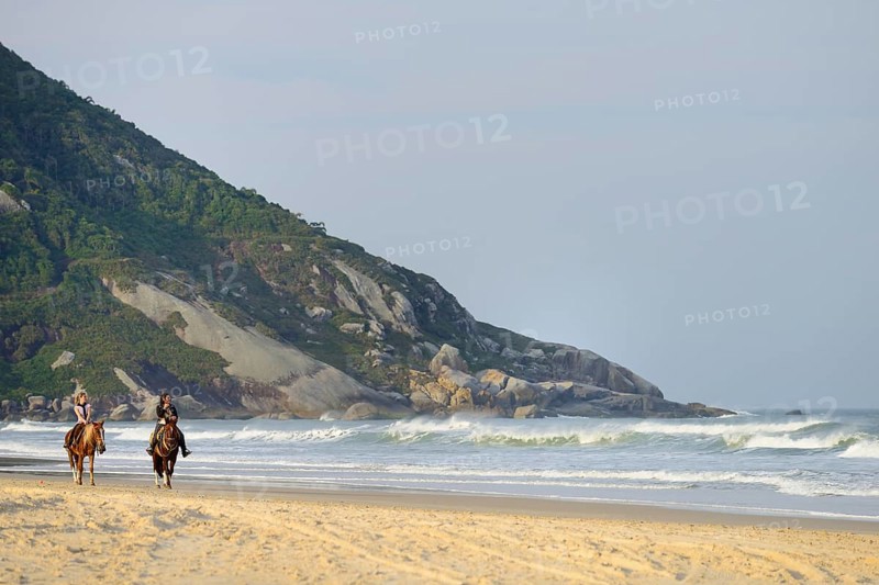 Two female riders on the beach