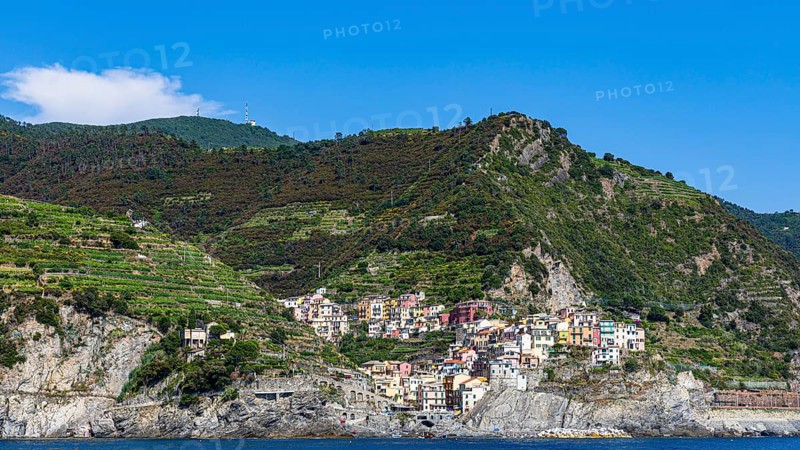 The village of Manarola with its nested pastel-coloured houses built into the hillside