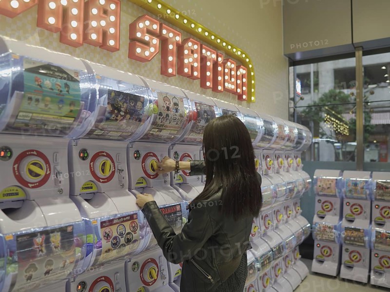 Girl at toy vending machine in Macau