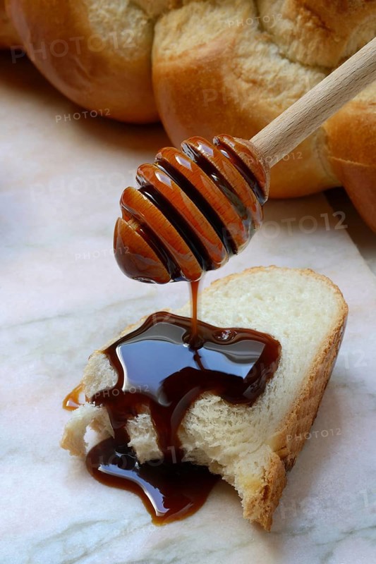 Yacon syrup drips onto a slice of yacon