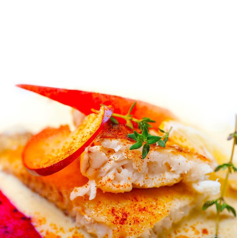Sea bream orata fillet butter pan fried with fresh peach prune and dragonfruit slices thyme on top