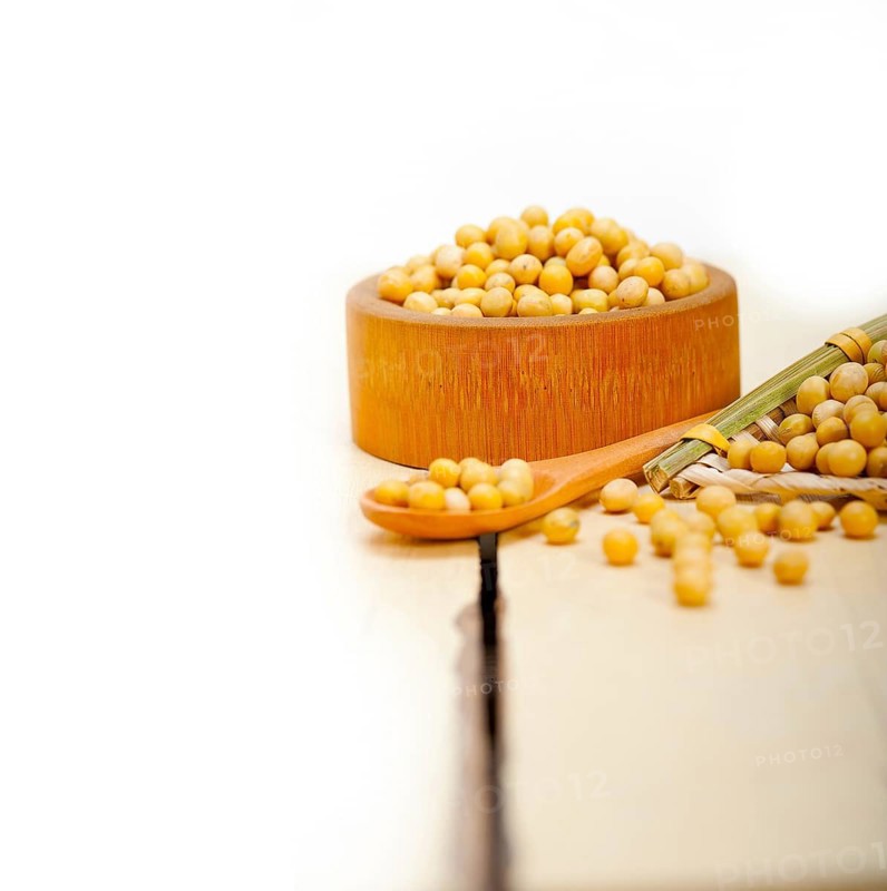 Organic soya beans over rustic wood table macro closeup