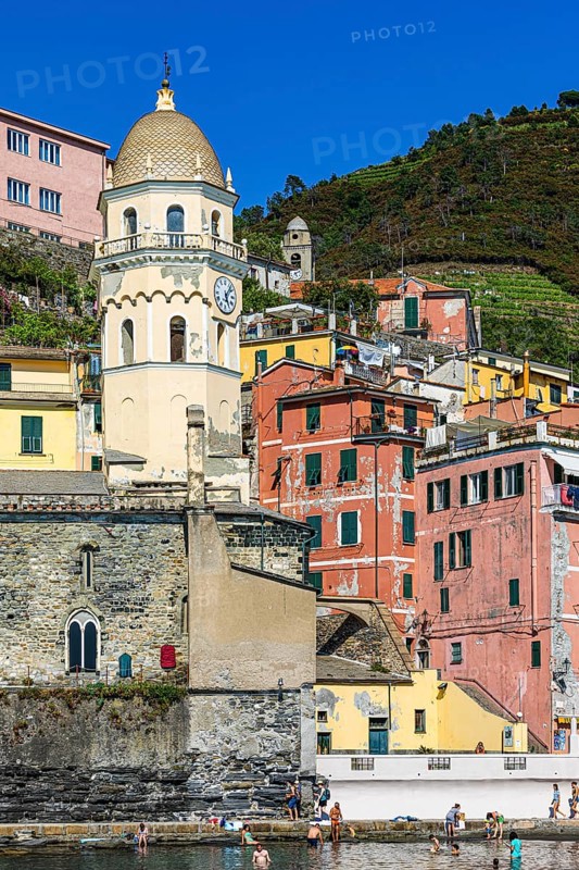 The church of Santa Margherita di Antiochia and nested houses built into the hillside with pastel-coloured facades