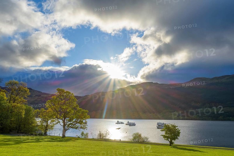 Lake with dramatic clouds and sun in spring