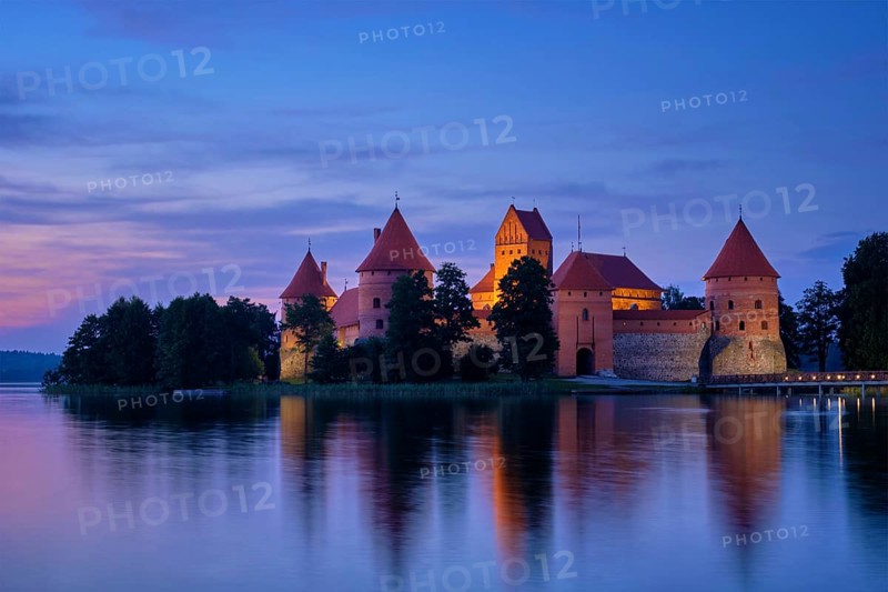 Night view of Trakai Island Castle in lake Galve illuminated in the evening