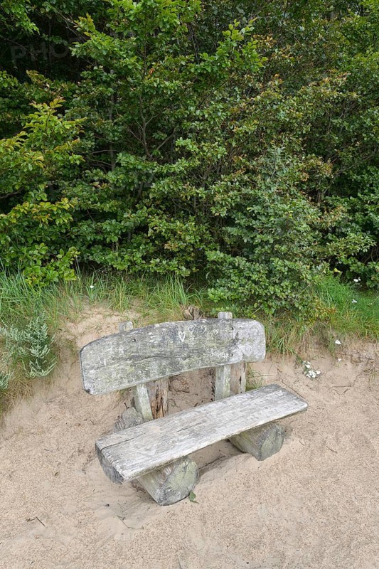 Bench on steep coast at sunrise