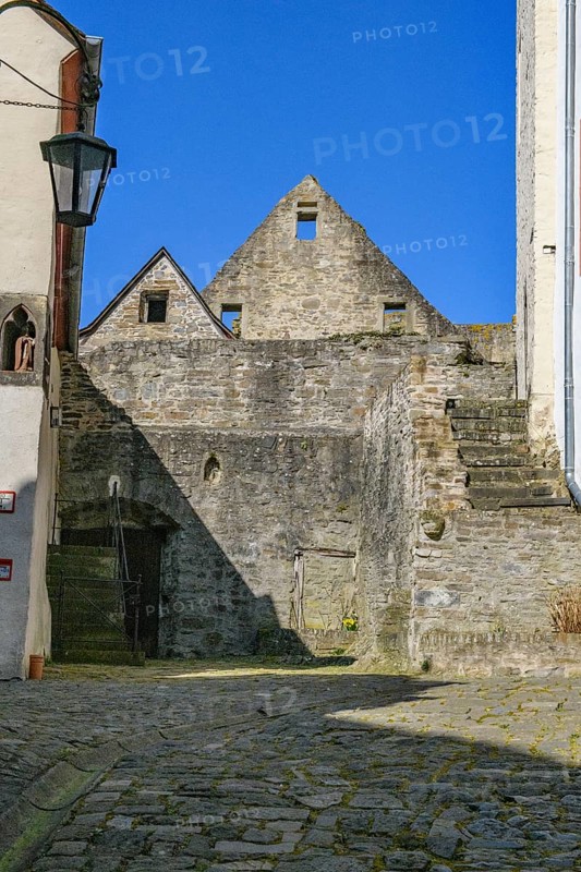 View from castle courtyard of Trier castle to ruin of Cologne castle in double castle Buerresheim from Middle Ages