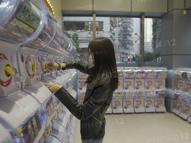 Girl at toy vending machine in Macau
