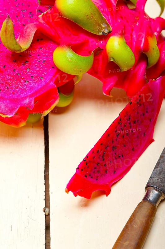 Fresh thai purple dragon fruit over white rustic table