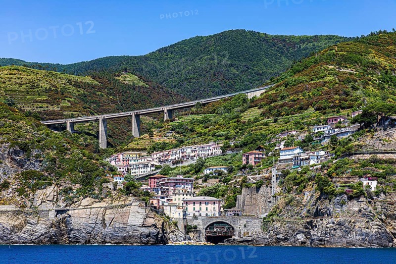 The village of Riomaggiore with its nested pastel-coloured houses built into the hillside