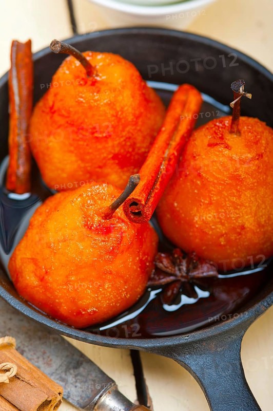 Poached pears delicious home made recipe ove white rustic wood table