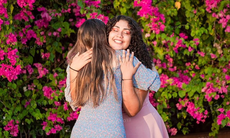 Two girlfriends hugging