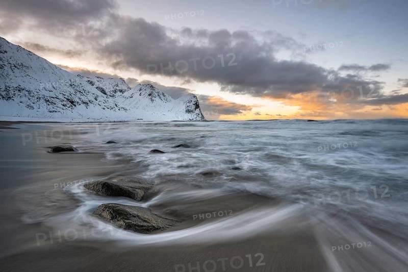 Beach with waves at sunset