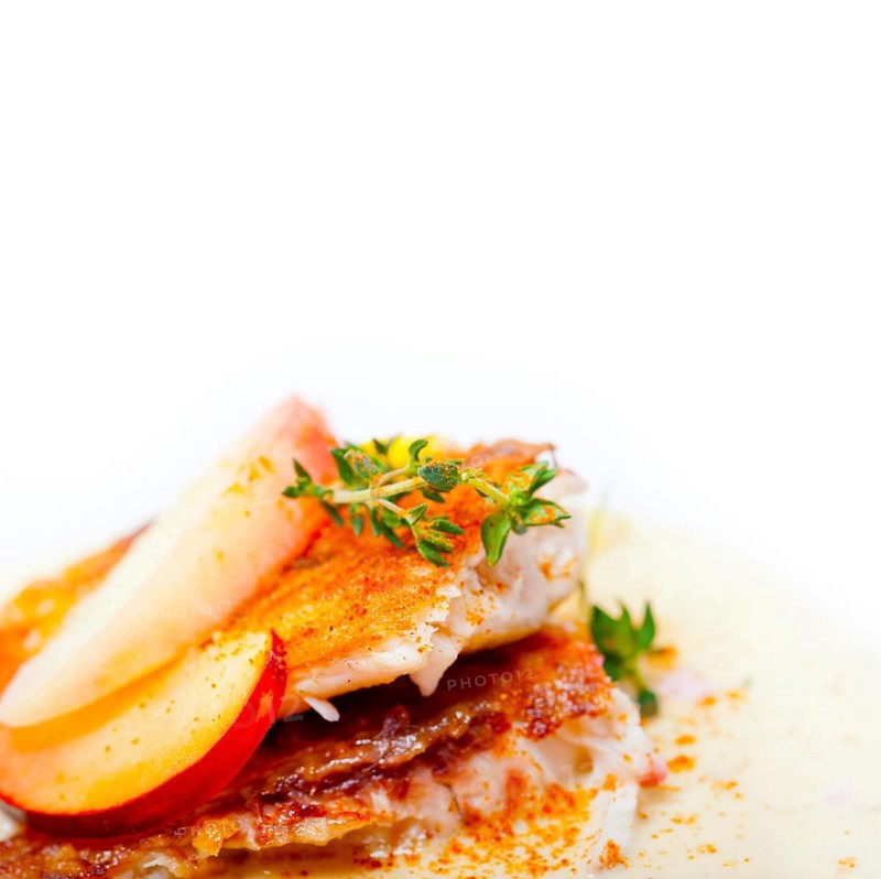 Sea bream orata fillet butter pan fried with fresh peach prune and dragonfruit slices thyme on top