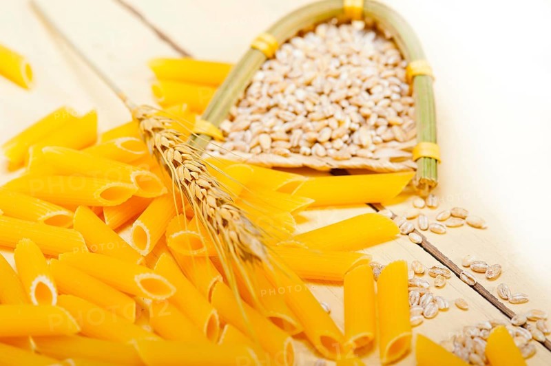 Short Italian pasta penne with durum wheat grains