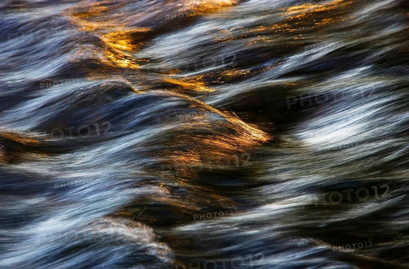 Flowing water with light reflections