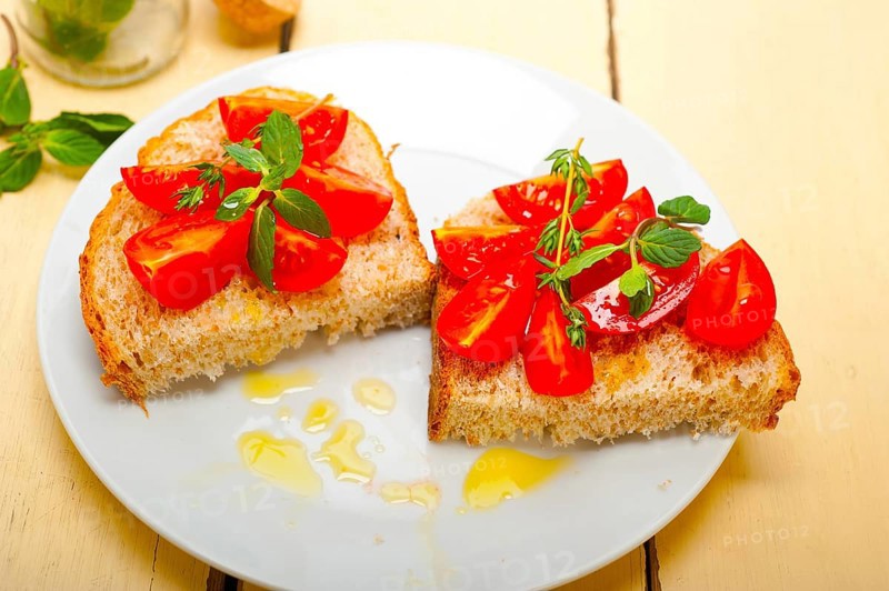 Italian tomato bruschetta with thyme and mint leaves