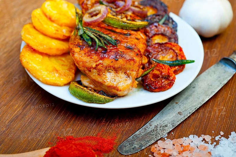 Roasted grilled BBQ chicken breast with herbs and spices rustic style