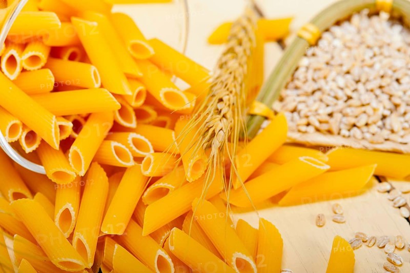 Short Italian pasta penne with durum wheat grains